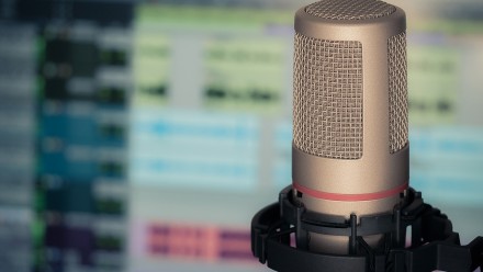 Microphone with blurred computer screen in background